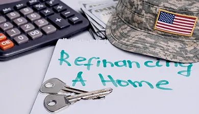 Keys, a hat, a calculator, and a note that says "refinance a home"